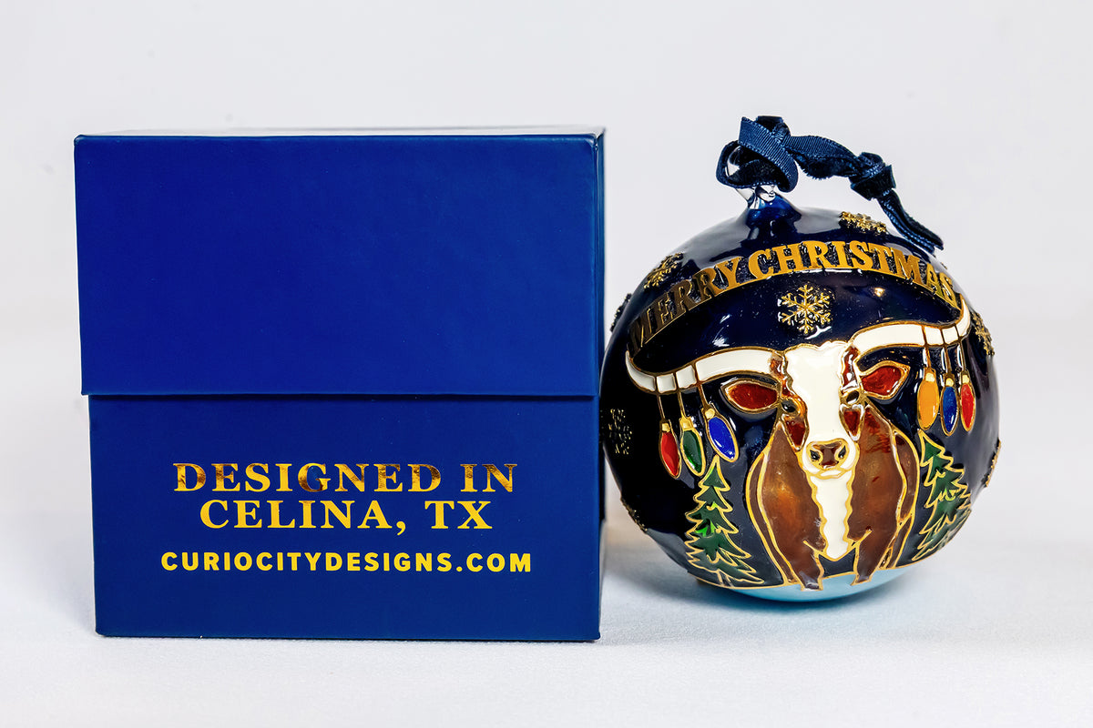 Celina 150th anniversary longhorn Christmas ornament beside the CurioCity Designs gift box marked Designed in Celina, TX.