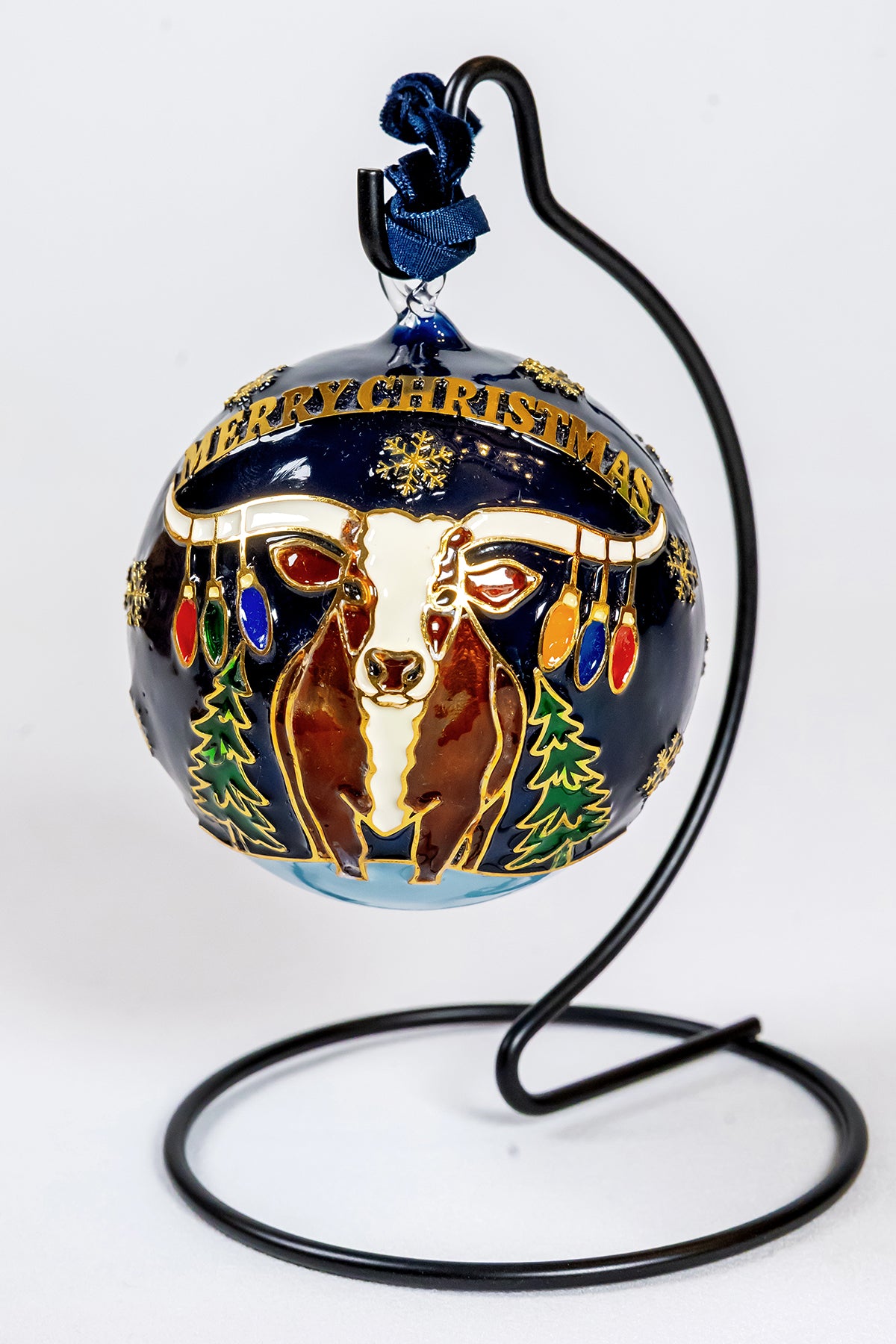 Reverse view of the Celina 150th anniversary ornament with a longhorn, Merry Christmas banner, colorful holiday lights, and evergreen trees.