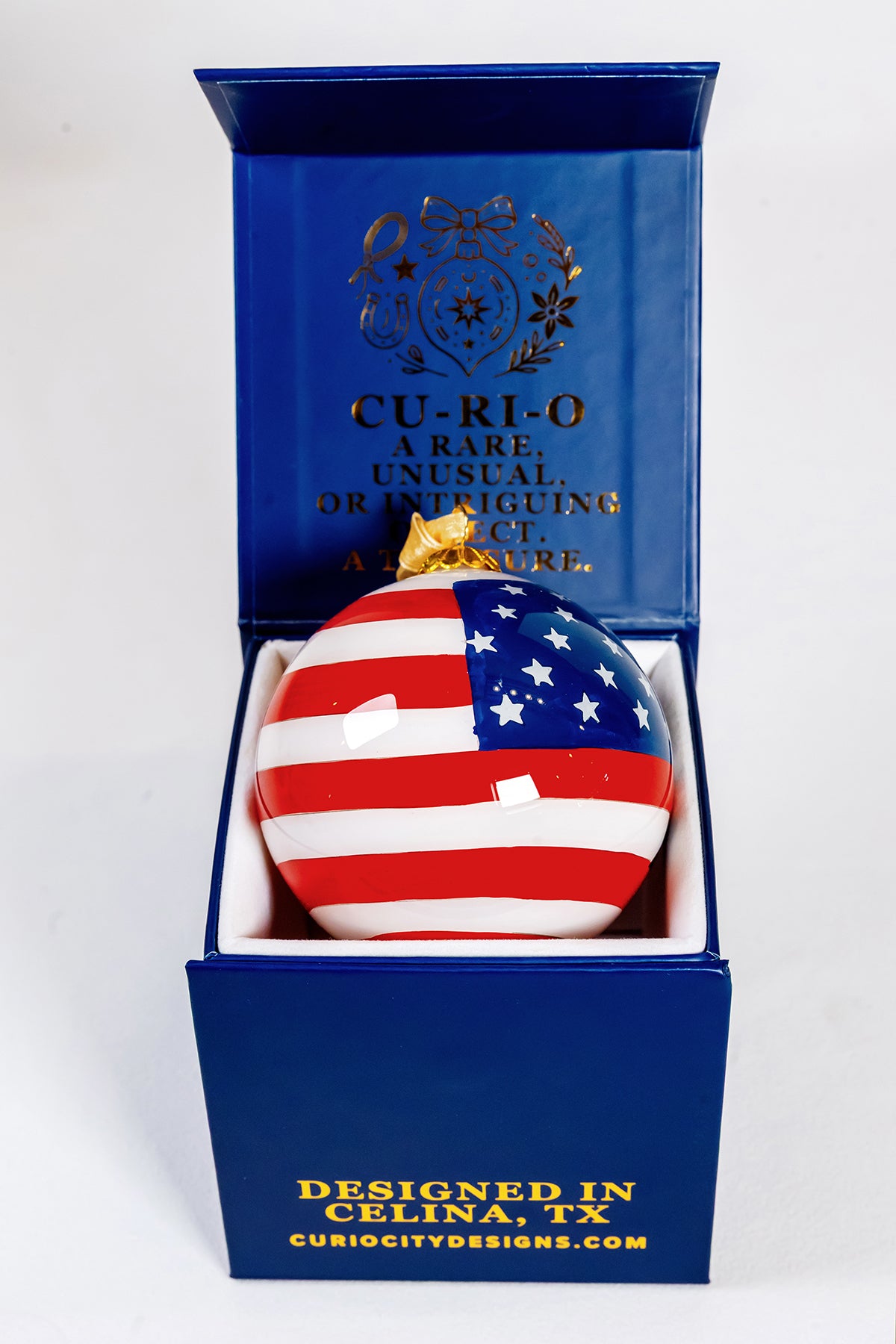 Back view of the God Bless the USA 250 Years hand-painted glass ornament in its CurioCity Designs keepsake gift box.