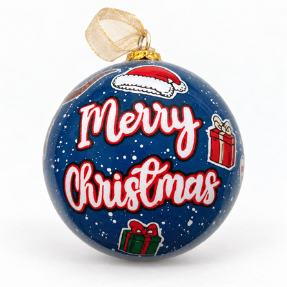 A Celina Christmas glass ornament styled with a gold ribbon, showing Merry Christmas lettering, a Santa hat, and wrapped gifts on a navy background.