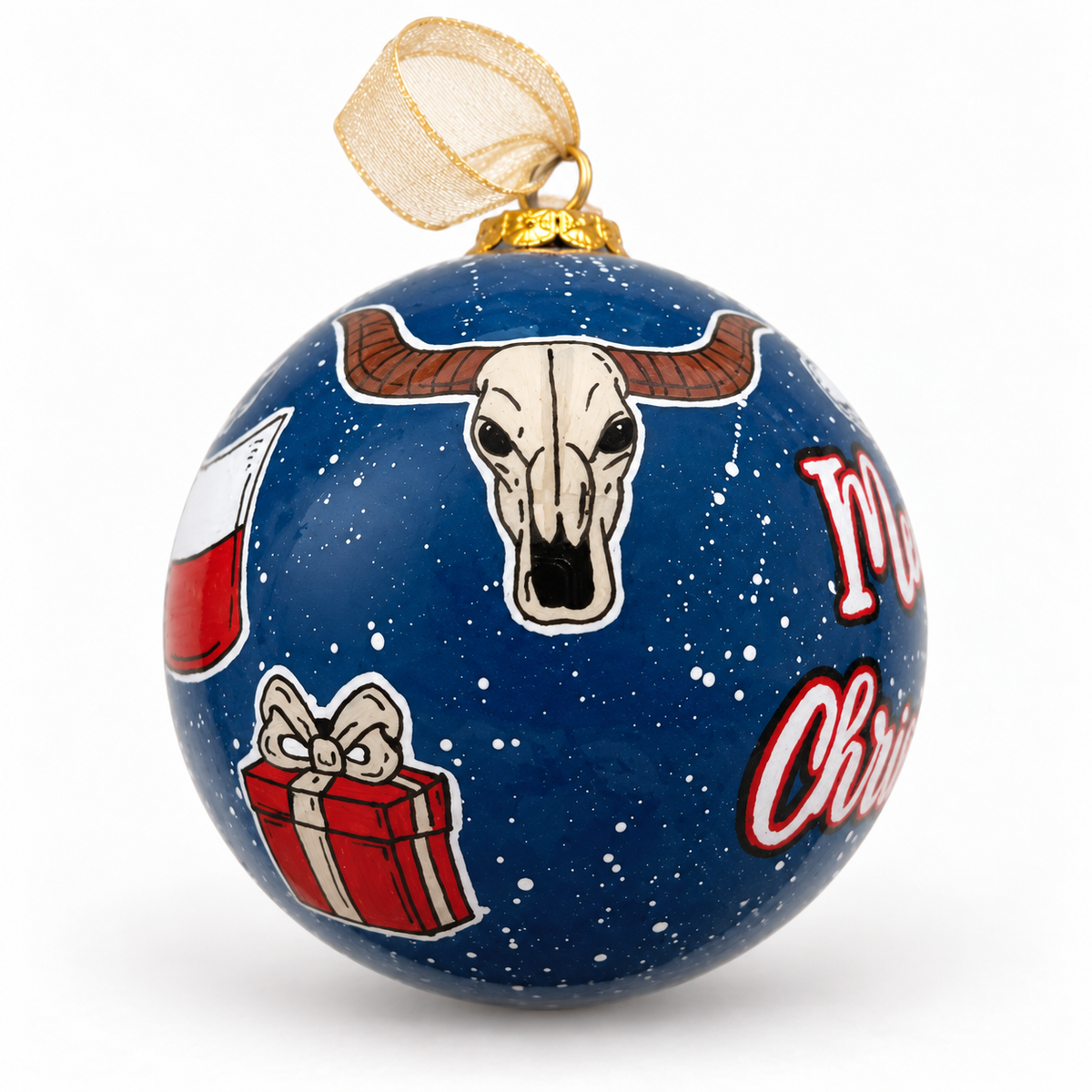 Longhorn-skull side of A Celina Christmas glass ornament, showing wrapped gifts and navy snowy paint, styled with a gold ribbon.