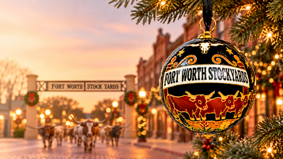 Cowtown Nights ornament in a festive Stockyards-inspired Christmas scene with a softly blurred cattle drive