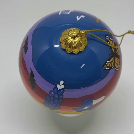 Short showcase video of a Fredericksburg Texas hand-painted glass ornament rotating against a clean white studio background