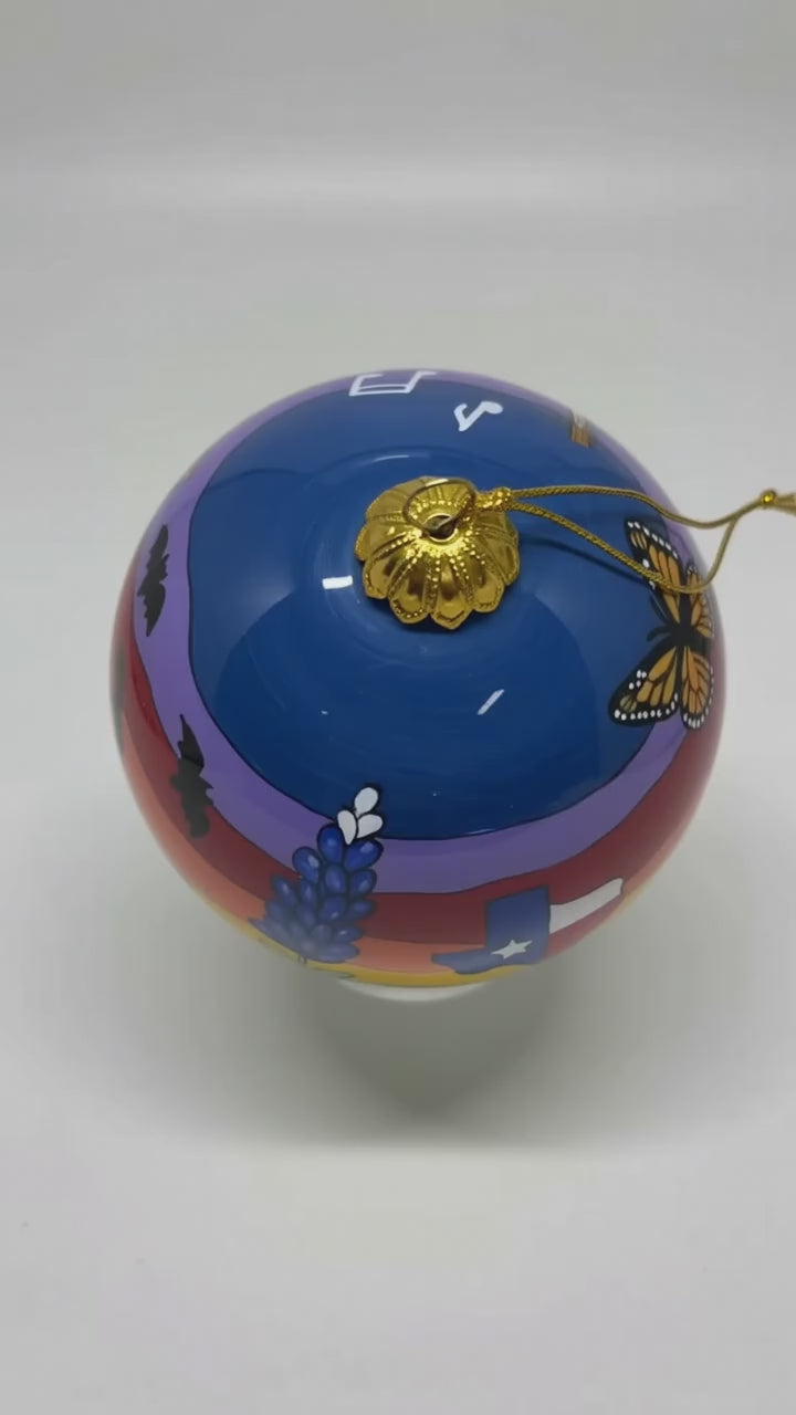 Short showcase video of a Fredericksburg Texas hand-painted glass ornament rotating against a clean white studio background
